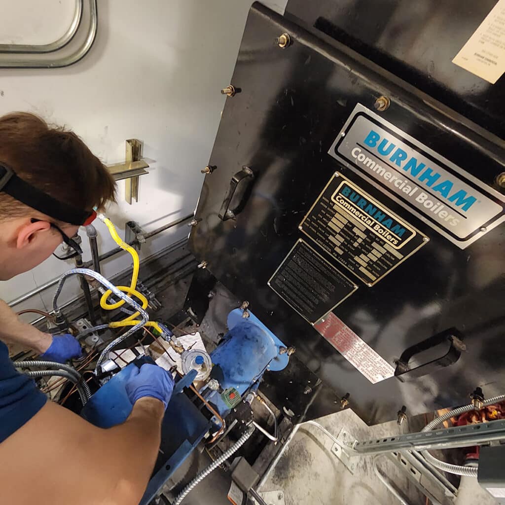 Man working on boiler system